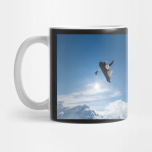 Snowboarder jumping against blue sky Mug